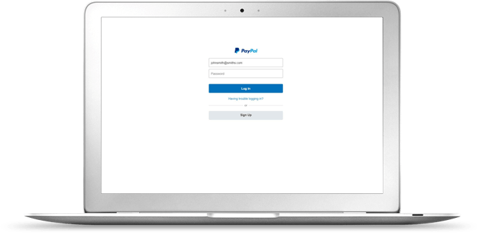 A laptop displaying the PayPal login page.