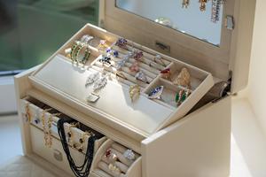 White jewelry box filled with rings and necklaces
