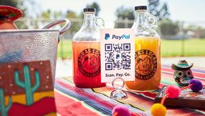 PayPal QR code on a sheet in front of two bottles of agua fresca