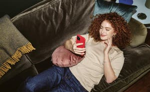 Woman sitting on a couch using her phone