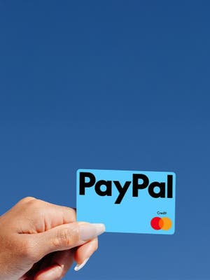 Person holding a New PayPal credit card.