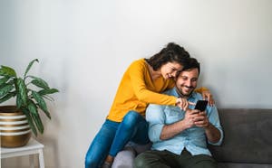 Couple smiling at a phone