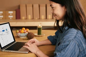Woman uses a laptop to make an online purchase. 