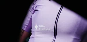 Close-up of Deià Studios logo on a lilac cycling jersey