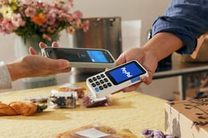 A shopper using a card at a terminal.