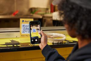 A customer pays with a QR code that links to a PayPal, a popular digital wallet solution.