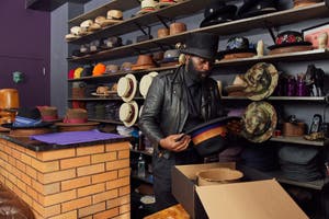A business owner packages a hat for shipment after a customer made a purchase using buy now, pay later.