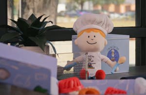 Photo of a desk with branded merchandise from the culinary education business I'm The Chef Too!