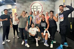 Group photo of Bell Fitness staff and clients smiling after a workout session.