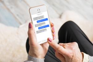A suspicious text message is displayed on a mobile device.