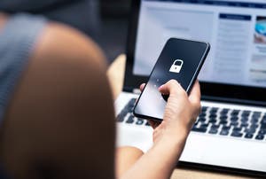 A mobile phone displays a potential online phishing attack