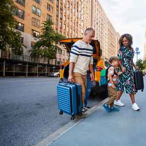 A happy family arriving at their travel destination; a tile of a flight and SUV booking with PayPal payment solutions
