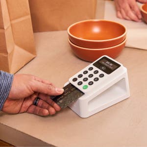 A customer paying for their purchase via credit card with the Zettle card reader