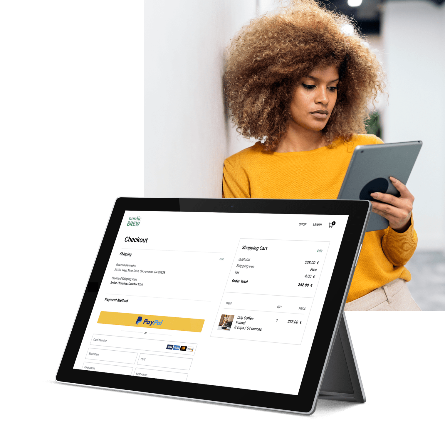 A woman is using her tablet to make a purchase online with PayPal