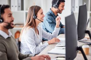 Call center, woman and working in team office with headset, computer, and online customer.
