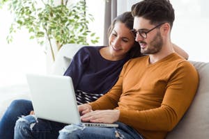 Two couple using a laptop at home.