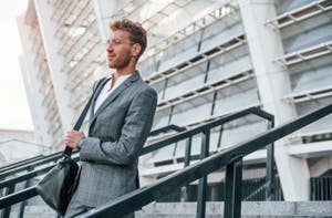 Man walking down stairs outside an office building