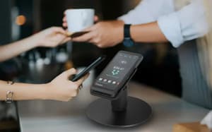 Customer making in-person payment using Verifone terminal.