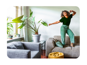 A person dancing happily on their couch
