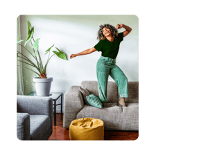 A person dancing happily on their couch