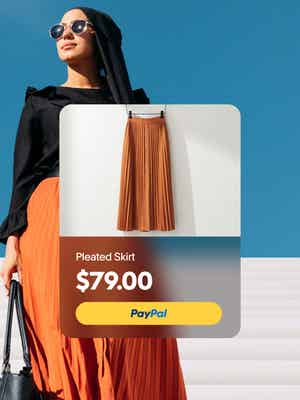 Person standing outside with overlay of pleated skirt product price $79 with PayPal button
