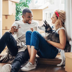 2 friends smiling and comparing mobile phones, illustrating an example of someone referring their friend to PayPal