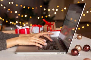 A female using laptop to do holiday shopping online