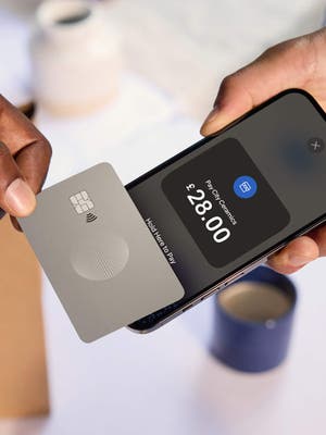 Customer checking out by tapping their card on a merchants phone