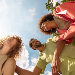 Two women, one man, all laughing together