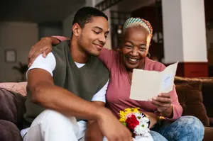 Woman and her son looking at a bank statement