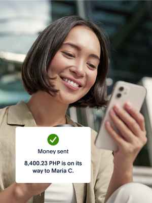 A woman holding a cup of coffee and her mobile phone; a tile showing money sent to Philippines on the app