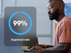 Person on a laptop with overlay of a 99% dial labeled Approval rate