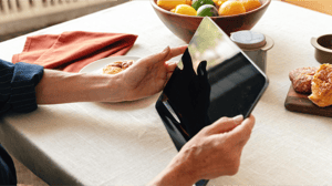 A person holding a brand new large tablet.