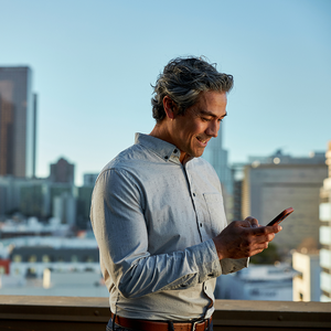 Man in a blue shirt holding a phone