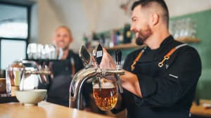 Two men working behind a bar