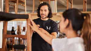 Man showing different types of chairs to a cusomter