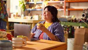 Woman sitting in a store holding a cup