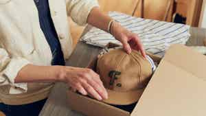 Person unboxing a hat