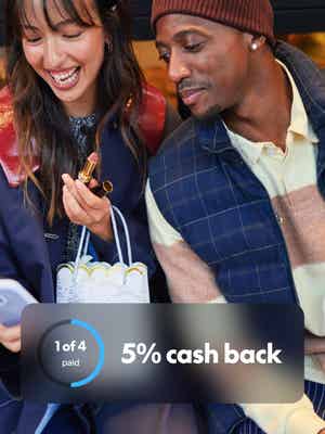 Man and woman looking at phone and smiling