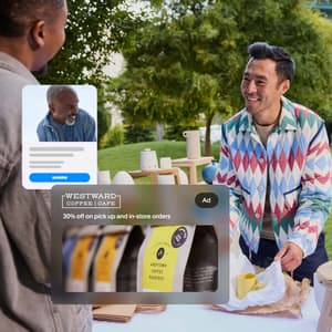 An image showing a man buying a mug at an outdoor market and he paid using PayPal.