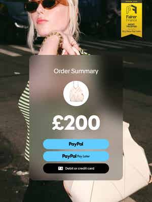 Woman smiling and taking a photo with an overlay of 3 interest-free payments of £158