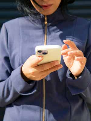 Person outside holding their phone