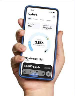 Hand holding a phone with UI of PayPal+ showing amount of points ready to spend