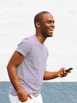 Man standing outside holding his phone