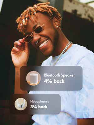Man wearing denim smiling with cash back offer overlay