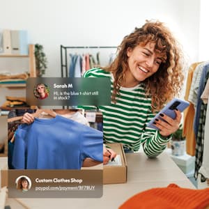 Small business owner using a smartphone in their clothing shop, with a customer message and payment link displayed in the foreground.