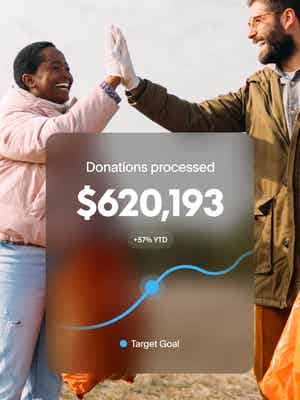 Two volunteers giving a high-five with overlay of $620,103 donations processed