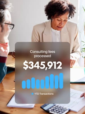 Consultant going over figures with clients with overlay of $345,912 Consulting fees processed in year-to-date transactions