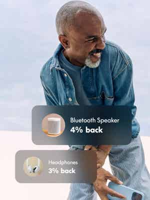 Man wearing denim smiling with cash back offer overlay