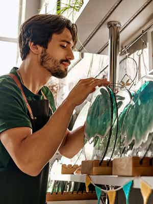 Man smiling while he inspects inventory